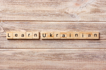 learn UKRAINIAN word written on wood block. learn UKRAINIAN text on table, concept