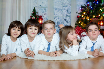 Five cute children, brothers, sister, siblings and friends, having fun on Christmas