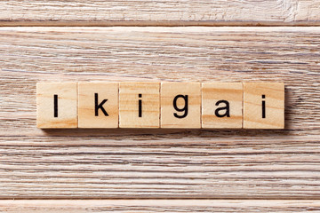 ikigai word written on wood block. ikigai text on table, concept