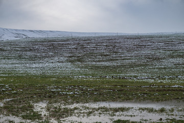 green hills covered by the first snow - winter is coming