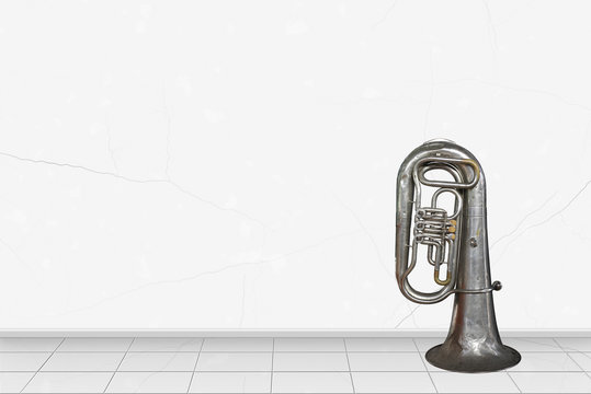 Home interior -   Vintage tuba in front of white wall