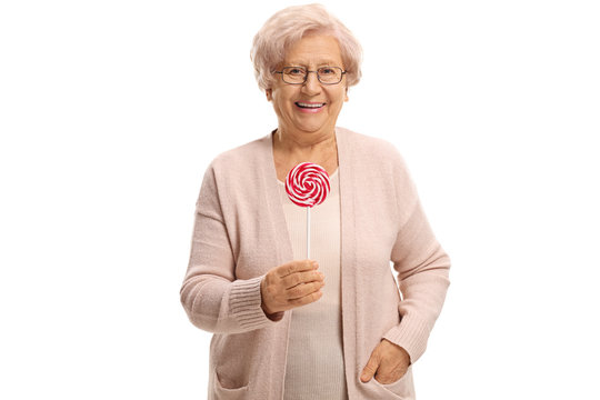 Joyful elderly woman with a lollipop