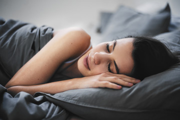 GIrl lying down in bed and sleeping