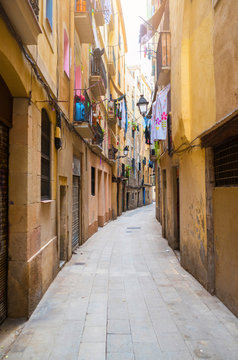 narrow alley in old town Ciutat Vella of Barcelona, Spain
