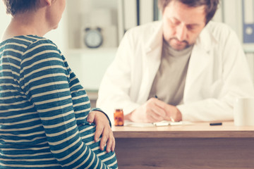 Fototapeta premium Doctor prescribing pills to pregnant woman