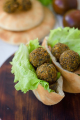 Falafel balls with lettuce salad and pita.