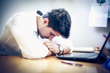 Businessman having a terrible headache. Close up.