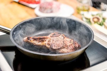 frying appetizing meat in restaurant kitchen