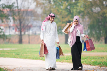 Lovely uslim couple taking a walk after shopping