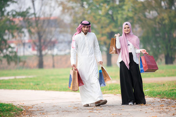 Lovely uslim couple taking a walk after shopping