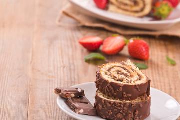Chocolate roll with hazelnuts and strawberries. 