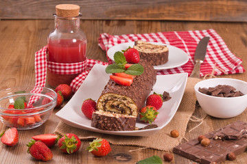 Chocolate roll with hazelnuts and strawberries. 