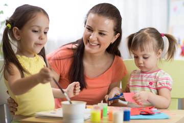 Fototapeta premium children girls and mother hands making at nursery at home