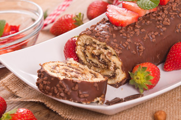 Chocolate roll with hazelnuts and strawberries. 