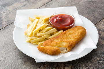 Traditional British fish and chips on wooden table. Copyspace
