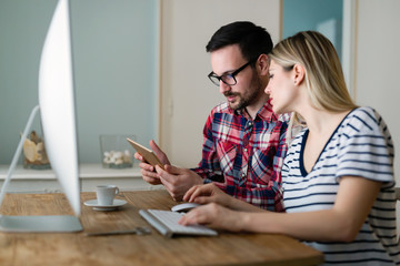 Young attractive designers working together from home