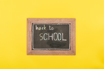 Top view of Back to school inscription on chalk board