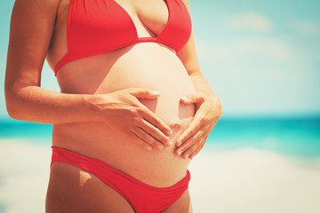 Fototapeta na wymiar Happy pregnant woman at beach