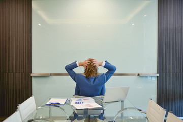 Western businessman presenting a project on blank glass board in meeting room