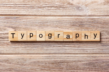 typography word written on wood block. typography text on table, concept