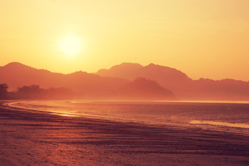 Fototapeta na wymiar beautiful landscape of sunrise over mountains at coast