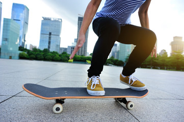 Fototapeta na wymiar Skateboarder ready to do a trick named ollie on city with skateboard