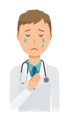 A young male doctor wearing a white suit is crying