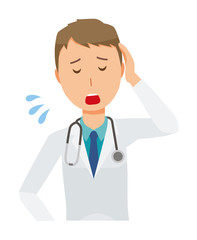 Fototapeta premium A young male doctor in a white suit is tired