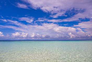 Landscape of clear and clean blue sea with cloudy sky.