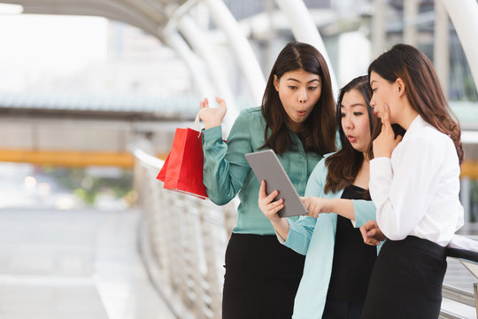 Asian business woman group happy shopping online with taplet in city women shopping concept