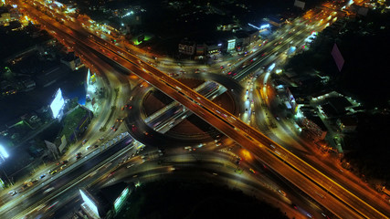 Fototapeta na wymiar Aerial view Road roundabout, Expressway with car lots in the city in Thailand.beautiful Street , downtown,cityscape,Top view. Background,Aerial view city scape