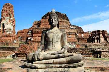 The ruins of ancient city with statue of Buddha. Ayutthaya Historical park. Ayutthaya, Thailand.