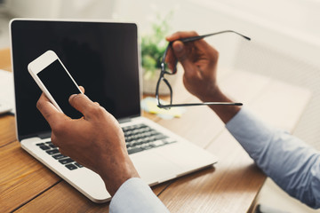 African-american businessman typing on laptop