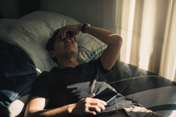 Obraz premium Sad man lying on the floor full of desperation thoughts .Portrait of thoughtful sad man alone. Fear, sadness, abuse, depression, addiction. 