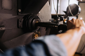partial view of coffee roaster working on roasting machine