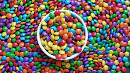 candy colorful confetti on white bowl scattered