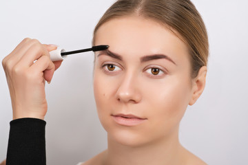 Young woman during an eyebrow correction procedure.