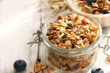 Homemade  Honey Granola in a glass jar, selective focus