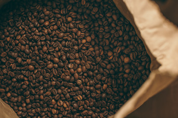 close up view of coffee beans in paper bag