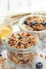 Homemade  Honey Granola in a glass jar, selective focus