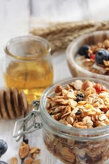 Homemade  Honey Granola in a glass jar, selective focus