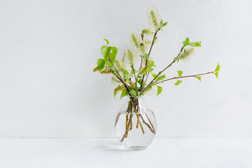 Spring bouquet with branches and green leaves