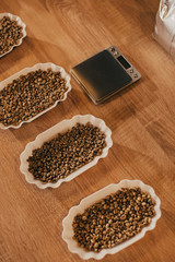 close up view of arranged bowls with coffee beans for food function on wooden tabletop