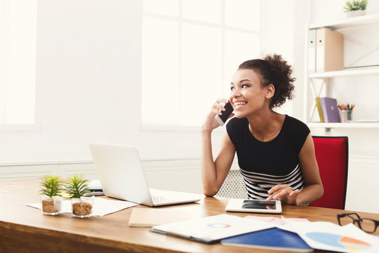 Happy Business Woman At Work Talking On Phone