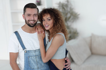 Happy young people standing in a new house