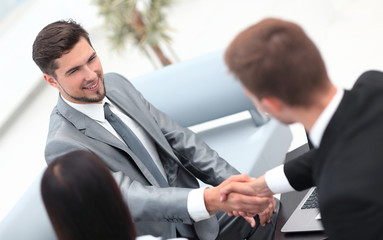 handshake business partners in the lobby of the office.