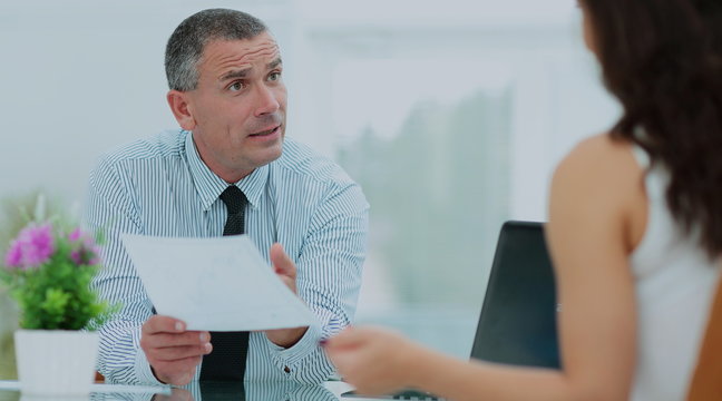 insurance agent shows the contract to the client in the office b