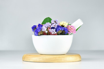 Alternative herbal and flower medicine, Mortar with healing botanical herbs.