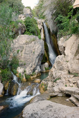 Mountain river with a waterfall among stones in Spain