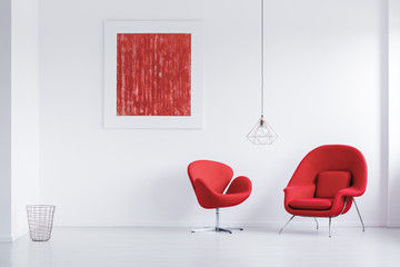 Modern red armchairs in room
